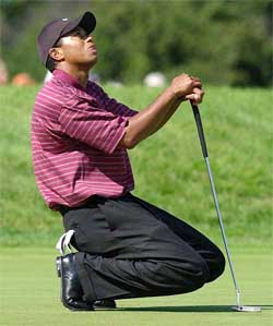 Tiger Woods reacts to a missed birdie putt 