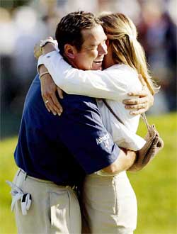 Rich Beem of the USA hugs his wife