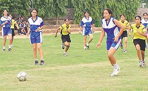 The opening tie of the second Chandigarh Junior Girls Football Championship between IS Dev Samaj School, Sector 21, and Sacred Heart School, Sector 26, in progress in Chandigarh on Tuesday.