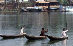 Kashmiri boatmen race against each other on Dal Lake
