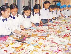 Students of Guru Nanak International Public School appreciate rakhis made by their school mates in a rakhi-making contest in Ludhiana on Tuesday.