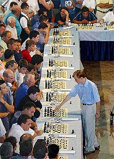Ukrainian Chess Federation Champion Ruslan Ponomariov, front right, plays chess with 25 players
