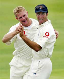 England's Matthew Hoggard celebrates taking the wicket of Virender Shewag with Michael Vaughan