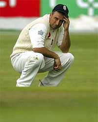 England's skipper Nasser Hussain puts his head in his hand