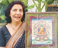Art collector Asha Chopra in the company of a Tibetan thangka.