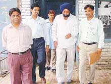 A section officer of the Chandigarh engineering wing, Raghbir Singh (turbaned), who was caught while accepting a bribe