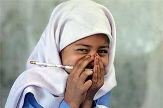 Shahida, a Kashmiri girl, shies away from the camera