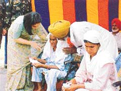 Ms Asha Mahajan, wife of Col V.K. Mahajan, listens to a war widow
