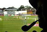 A cricket fan smokes a pipe