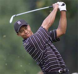 Tiger Woods tees off on the first hole