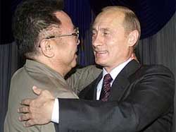 Russian President Vladimir Putin smiles as he greets North Korean leader Kim Jong-II
