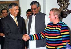 US Ambassador to Pakistan Nancy Powell shakes hand with Pakistani Finance Minister Shaukat Aziz