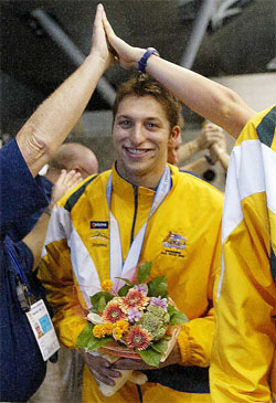 Australian swimming sensation Ian Thorpe walks through a victory arch