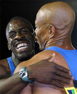Britain's Dwain Chambers hugs America's Maurice Greene