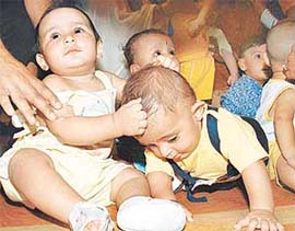 Chubby babies cuddle together 