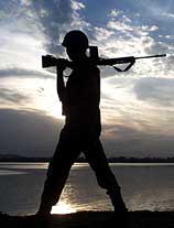 A paramilitary jawan patrols around Dal Lake