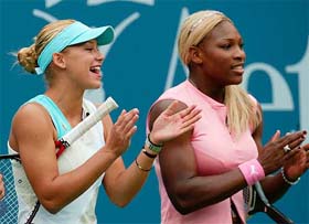 Serena Williams and Anna Kournikova laugh during Arthur Ashe Kids Day festivities 