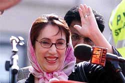 Former Prime Minister Benazir Bhutto greets supporters at a rally
