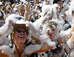 Young Hungarians dance in foam during the Budapest Parade on Saturday