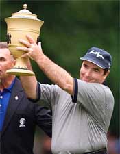 Craig Parry of Australia holds up the tournament trophy