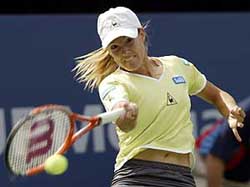Justine Henin of Belgium returns to Samantha Reeves