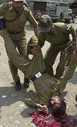 The body of a policeman being removed from the road