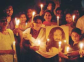 Members of ��Art Of Living��hold a candlelight procession to create awareness about pollution caused by the excessive use of polythene bags at Model Town in Ludhiana 
