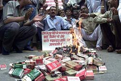 Activists of the National People's Right Front burn tobacco goods