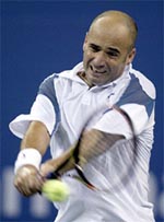 Andre Agassi of the USA returns the ball to compatriot Robby Ginepri