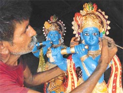 Padam Ram, a Jodhpur artisan, gives finishing touches to the idols of Lord Krishna 