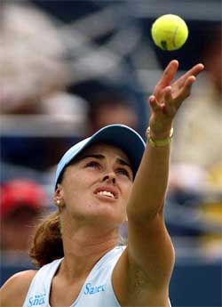 Martina Hingis of Switzerland serves to Marissa Irvin of the USA