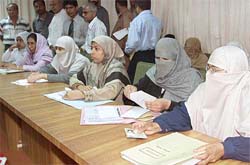 Candidates belonging to the Islamic parties alliance, Muthedda Majlis-e-Ammal, sit with their documents