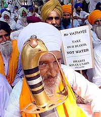 Bhartiya Kissan Union (Punjab) activists sit on a dharna