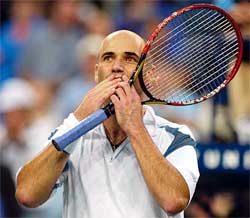 Andre Agassi of the USA blows a kiss to the crowd after defeating compatriot Justin Gimelstob 