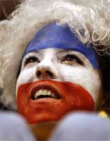 A Yugoslavian fan wears her countries flag painted on her face as she watches her team defeat Angola 113-63