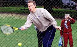 Britain's Prime Minister Tony Blair returns a shot 