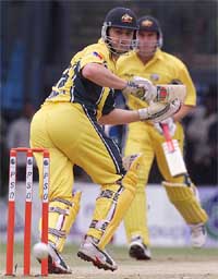 Australia's batsman Mathew Hayden (R) hits a four as his team vice-captain Adam Gilchrist looks on