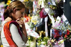 A member of the public views floral tributes left for Britain's late Princess Diana