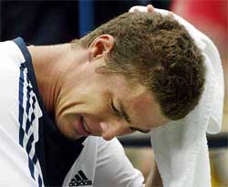 Marat Safin of Russia sits near the end of his loss to Gustavo Kuerten