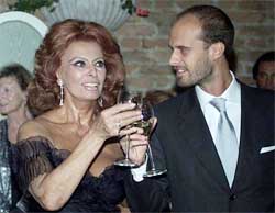 Italian actress Sofia Loren clinks glasses with her son Edoardo after receiving the Bianchi Award at the Venice Lido on Friday