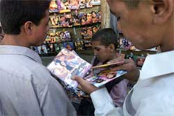 Afghans look at Indian music and VCDs in a Kabul street market