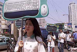 Models promote computer products in a Shanghai