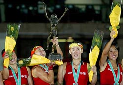 China's Fu Baorong and Tang Chunling hold aloft the championship trophy