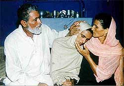 Muktar Mai, the 30-year-old divorced victim of a June 22 tribal gang-rape, is comforted by her mother and uncle