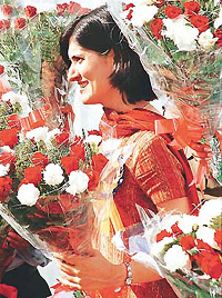 A law officer, holding a bouquet waits at the Haryana Advocate-General�s office for Union Law Minister K. Jana Krishnamurthy