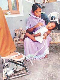 Sanjeev, a two-year-old boy, in his mother�s lap being given air pressure in Sector 70, SAS Nagar on Thursday.