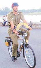 A policemen patrols at the Sukhna Lake on a bicycle.