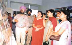 The Principal of the school, Ms Charanjit Mahal, and staff members at a photo exhibition