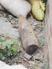 Sandbags cover a live bomb dumped on roadside in Focal Point