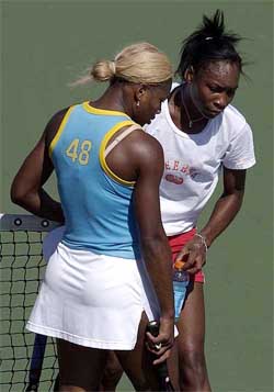 U.S. Open semi-finalists Serena (left) and Venus Williams are shown on a practice court